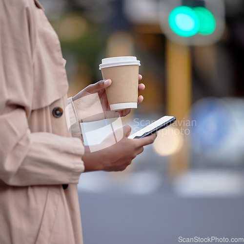 Image of Phone, hands and black woman with coffee in city, internet browsing or social media. Business mobile, tea and female employee with smartphone for networking, text messaging or web scrolling in town.