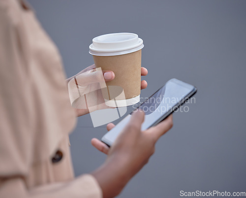 Image of Business phone, hands and black woman with coffee, internet browsing or social media. Mobile, tea and female employee with smartphone for networking or web scrolling isolated on a gray background.