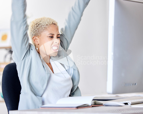 Image of Winner, success and motivation with a business black woman cheering while working in an office. Wow, winning and celebration with a female employee sitting arms raised after reaching a target or goal