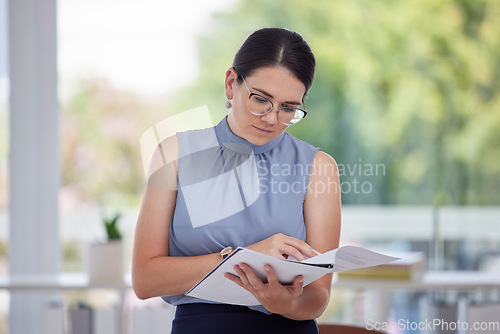 Image of Business woman, paperwork and reading at the office for financial report, analysis or information. Female HR employee worker checking document for finance, insurance or corporate loan at workplace