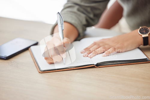 Image of Woman hands, writing and notebook for planning schedule, agenda or list with a pen on an office table. Book, planner or journal with creative ideas, strategy or goals as inspiration for writer person