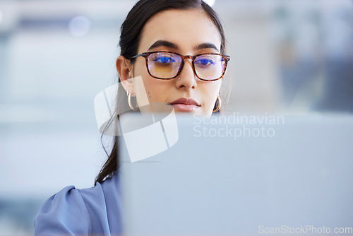 Image of Business woman, glasses and working on laptop in office, agency and startup company. Focus, face and female worker on computer technology for email, internet planning and professional seo research