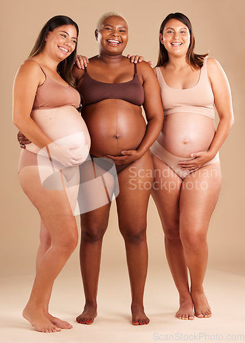 Image of Pregnant, body and portrait of women in belly support touch, hope and community diversity on studio background. Smile, happy and pregnancy friends in underwear, stomach growth and healthcare wellness