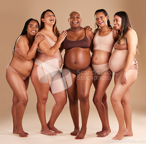 Image of Pregnant, body and laughing group of women in diversity support, solidarity and community on studio background. Smile, happy or pregnancy friends in underwear, funny or comic joke with stomach growth