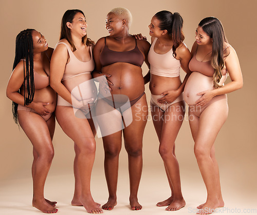 Image of Women group, pregnant or body and stomach touch in baby support, diversity solidarity or excited on studio background. Smile, happy or pregnancy friends in underwear, funny joke or comic belly growth