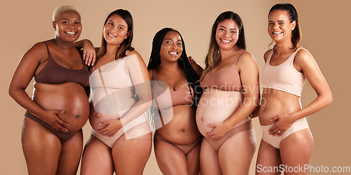 Image of Pregnancy body, portrait and bonding women on studio background in diversity empowerment, baby support and community. Smile, happy and pregnant friends in underwear with stomach growth, touch or love