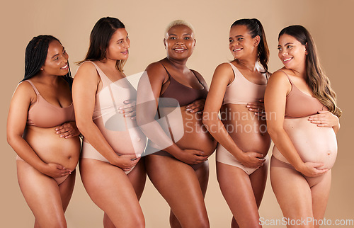 Image of Happy women, body or holding pregnant stomach in support line, solidarity or community diversity on studio background. Pregnancy, friends and people in underwear for belly growth or mothers day pride