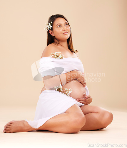 Image of Pregnancy, pregnant woman with flowers sitting, beauty and glow isolated on studio background. Skin, shine and natural cosmetics with nature, happy mother with prenatal cosmetic care mockup