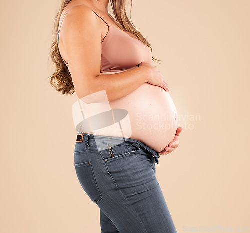 Image of Pregnant, woman and stomach on studio background for body, maternity wellness and healthcare. Closeup abdomen, belly and pregnancy of mother model for beauty, gynecology and natural birth of new life