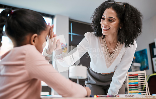 Image of High five, success or teacher in celebration with a student in a classroom with learning development. Goals, education or happy black woman smiles teaching or celebrates a target with a school girl