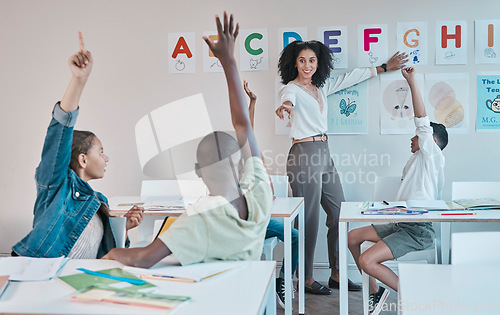 Image of Question, learning and education at school with kids hands raised to answer alphabet assessment. Classroom, learners and tutor teaching a summary information in a class with smart and clever group