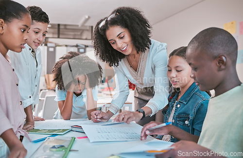 Image of Female teacher helping children with assignment, classroom in school and writing notes in book. Diversity in student group, educator reading kids notebook and learning together for assessment