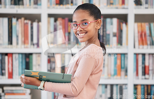 Image of Books, education or girl reading in library for knowledge or development for future growth. Scholarship, portrait or school student with a happy smile studying or learning information in a fun story