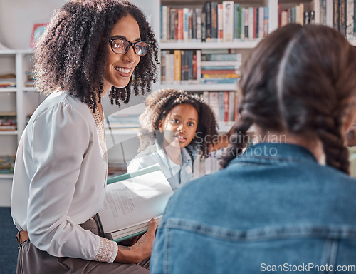 Image of Teacher, storytelling or children in a library for learning development, reading skills or growth. Happy smile, kids or students listening to a black woman asking for feedback on fun books at school