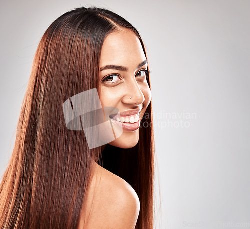 Image of Smile, portrait and woman in studio for hair, beauty and salon treatment on grey background. Face, haircare and model relax with luxury, care and shine, keratin and smooth results isolated