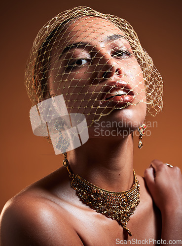 Image of Beauty, fashion and veil with portrait of woman for gold, jewellery and vintage luxury. Cosmetics, retro and glamour with net on face of girl model for fancy, graceful and accessory in studio