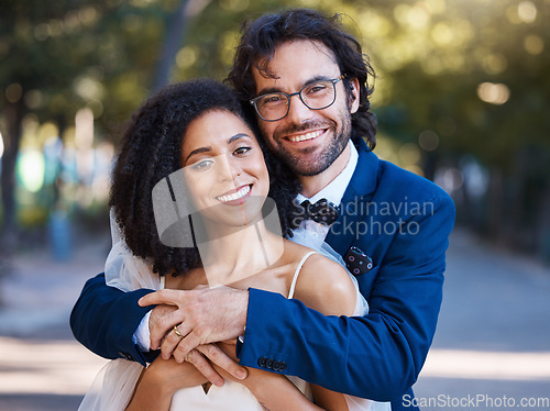 Image of Happy, couple portrait and outdoor for wedding celebration event with a hug for commitment. Interracial man and woman at park with trust, partnership and love in marriage with support and care