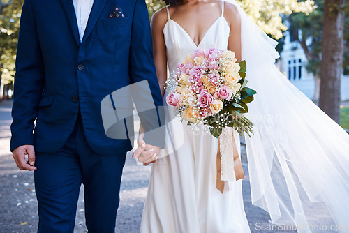 Image of Bouquet, wedding and love of bride, groom and outdoor photograph at celebration, event or reception. Roses, flowers and marriage of bridal couple, romance and park in commitment, union or partnership