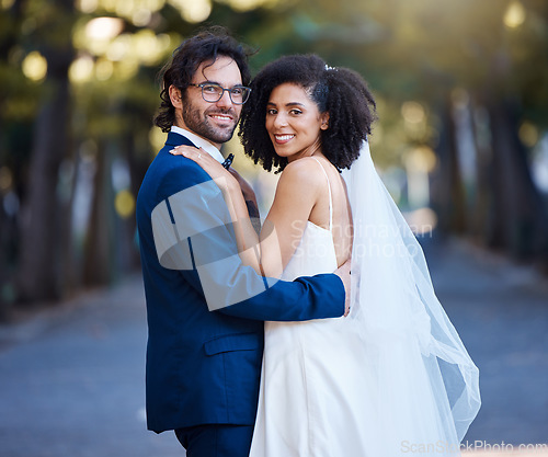 Image of Couple portrait, wedding and interracial love outdoor for marriage celebration event together with care. Happy married man and woman at park with trust, partnership and hug for happiness and security