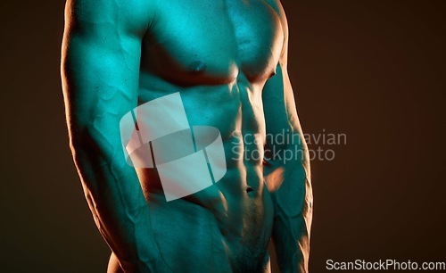 Image of Body, art and abs with a nude man in studio on a dark background for artistic expression or freedom. Creative, sexy and muscle with a naked male model posing to promote artwork, sensuality or fitness