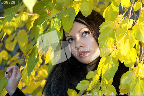 Image of Portrait of the young woman in foliage