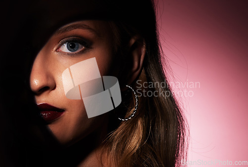 Image of Glamour makeup and face of woman with spotlight shadow for hidden beauty aesthetic portrait of people zoom in studio. Skincare and dark lipstick style of attractive person in isolated pink background