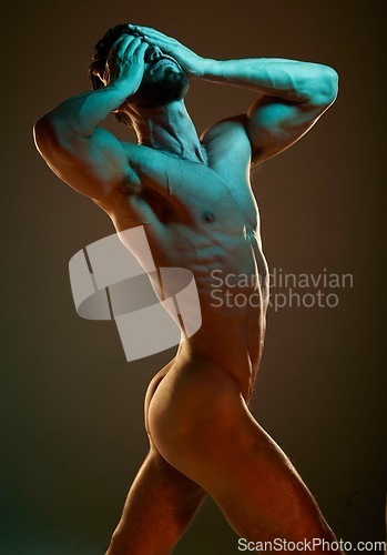 Image of Nude, body and muscular with a dramatic man in studio on a dark background for art or self expression. Fitness, naked and hands covering face with a male model posing for health, wellness or artwork