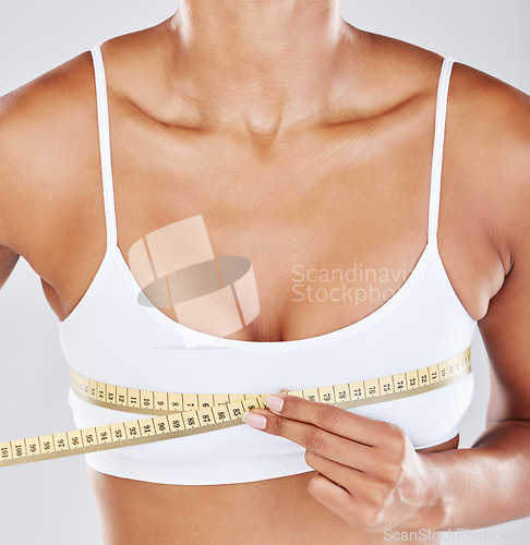 Image of Chest, measure tape and woman isolated on white background for breast cosmetics, plastic surgery and lose weight. Liposuction, health or wellness person or model with boobs for beauty results in zoom