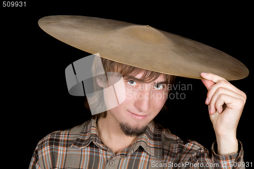 Image of The young man with a plate from a drum on a head