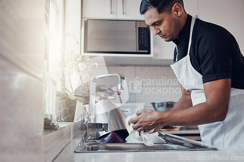 Image of Cleaning kitchen, washing dishes and a man in house, home or apartment to clean for safety from bacteria. Male cleaner person at sink with a cloth in hands for hygiene and a healthy lifestyle