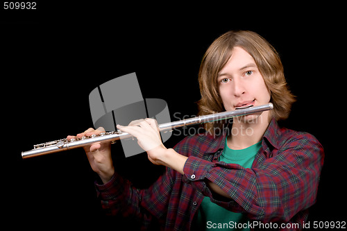 Image of The young man plays a flute over black