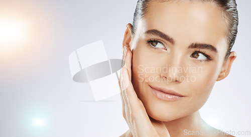 Image of Skincare, thinking and face of a woman with beauty isolated on a grey studio background. Flare, dermatology and young healthy model with facial wellness, collagen and body detox on mockup backdrop