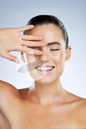 Image of Skincare, beauty and happy face of a woman in studio with a smile for natural cosmetic product. Aesthetic model person with hand for makeup, facial and dermatology for skin glow and spa wellness