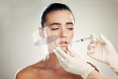 Image of Skincare, beauty and woman with injection in lips from healthcare professional, anti aging wrinkle treatment in studio. Collagen, needle and model with facial lip filler syringe on white background.