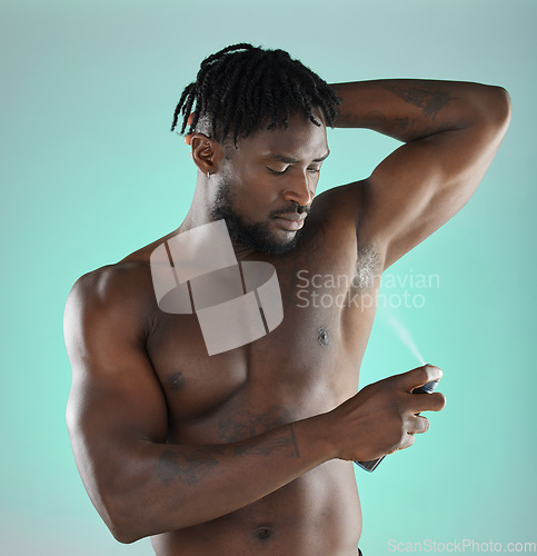 Image of Body hygiene and black man with deodorant spray product for self care routine of people in studio. Health, wellness and cosmetic grooming of person with skincare at isolated green background.