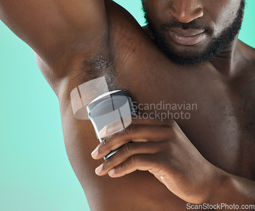 Image of Armpit hygiene and black man with deodorant and self care routine product of people with body zoom in studio. Health, wellness and cosmetic grooming of young person at isolated green background