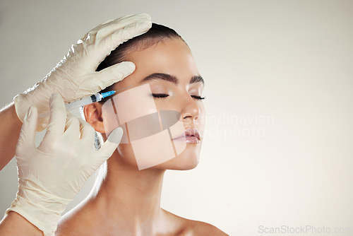 Image of Dermatology, woman or injection for plastic surgery, beauty or filler with gloves on studio background. Lady, female or collagen for skincare, needle for procedure or cosmetics for healthy skin