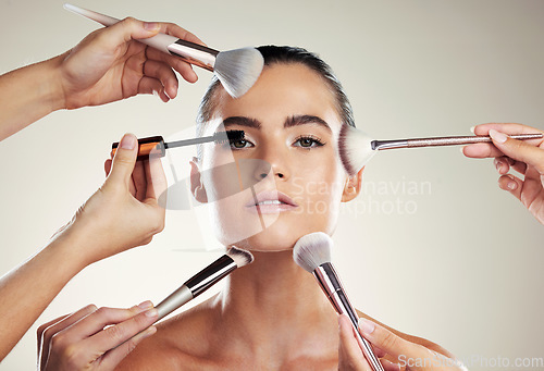 Image of Makeup, beauty and brush on face of a woman in studio for powder cosmetic product. Aesthetic model person with professional hands for facial skincare and dermatology for skin glow and salon results