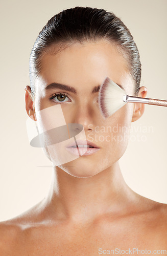 Image of Portrait, brush for makeup and woman with face, beauty and skincare with cosmetic tools isolated on studio background. Foundation, skin glow and cosmetics, wellness and dermatology with microblading