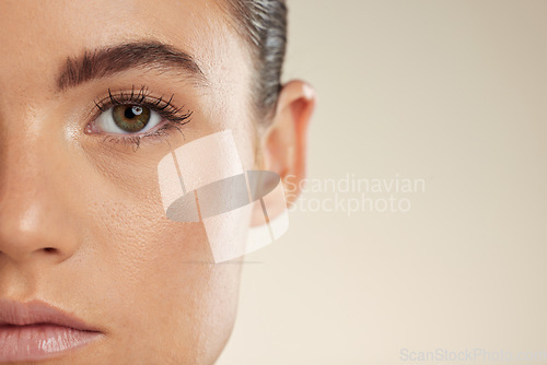 Image of Beauty, skincare and half face of woman on mockup space for cosmetics, makeup and facial products. Spa aesthetic, dermatology and portrait of girl with glowing skin, self care and wellness in studio