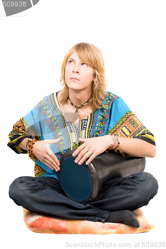 Image of The young man plays a drum looking upwards