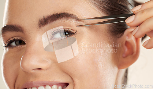 Image of Face, beauty and woman portrait with tweezer for eyebrow cleaning or hair removal in studio. Happy aesthetic model with a smile for facial, cosmetic tools and clean skin for self care routine