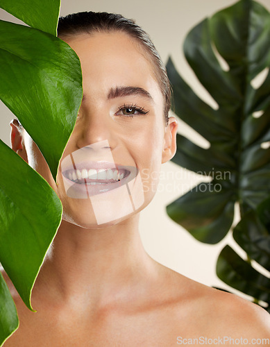 Image of Beauty, skincare and woman portrait with green plant for natural skin dermatology cosmetic product. Happy face of aesthetic model in studio for sustainable glow or makeup for health and wellness