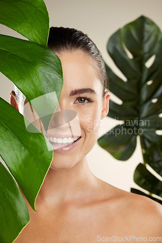 Image of Woman, beauty and skincare portrait with plant for natural skin dermatology or cosmetic product. Happy face aesthetic model in studio for sustainable self care with green leaf for health and wellness