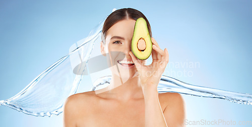 Image of Skincare, beauty and woman portrait with avocado for natural skin dermatology cosmetic product. Water splash and face of aesthetic model in studio for sustainable self care for health and wellness