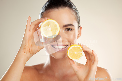 Image of Skincare, face portrait and happy woman with lemon for natural fruit detox, health wellness or facial beauty glow. Spa salon, dermatology healthcare and nutritionist model with vitamin c food product