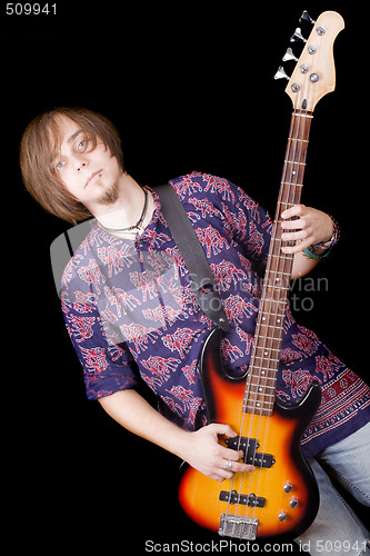 Image of The young man with a guitar over black