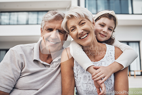 Image of Portrait, girl and grandparents relax in real estate, new home and backyard, hug and happy while bonding. Face, grandchild and senior man and woman enjoy property, retirement and embrace in a garden