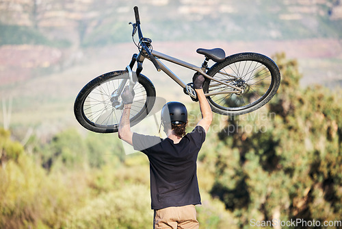 Image of Bicycle, athlete and outdoor and sports athlete with fitness and cycling sport on mountains. Energy, moving speed and freedom with a bike in the air doing a fast road race with trees and helmet