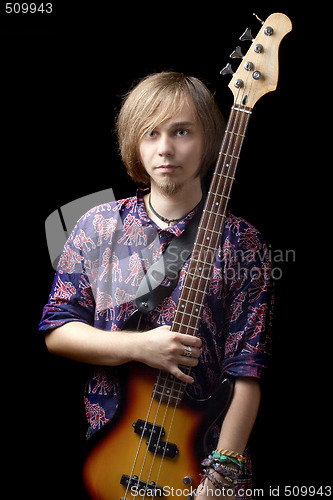 Image of Young man with a guitar over black